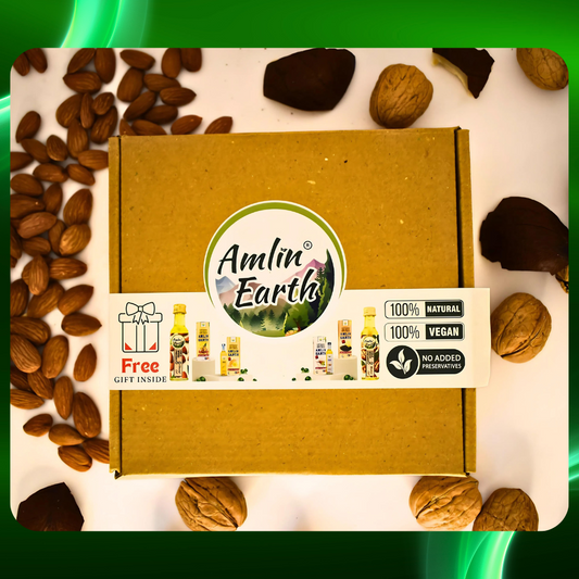 Amlin Earth Nourish & Glow Gift Pack with cold wood press oils, featuring eco-friendly packaging surrounded by almonds and walnuts.